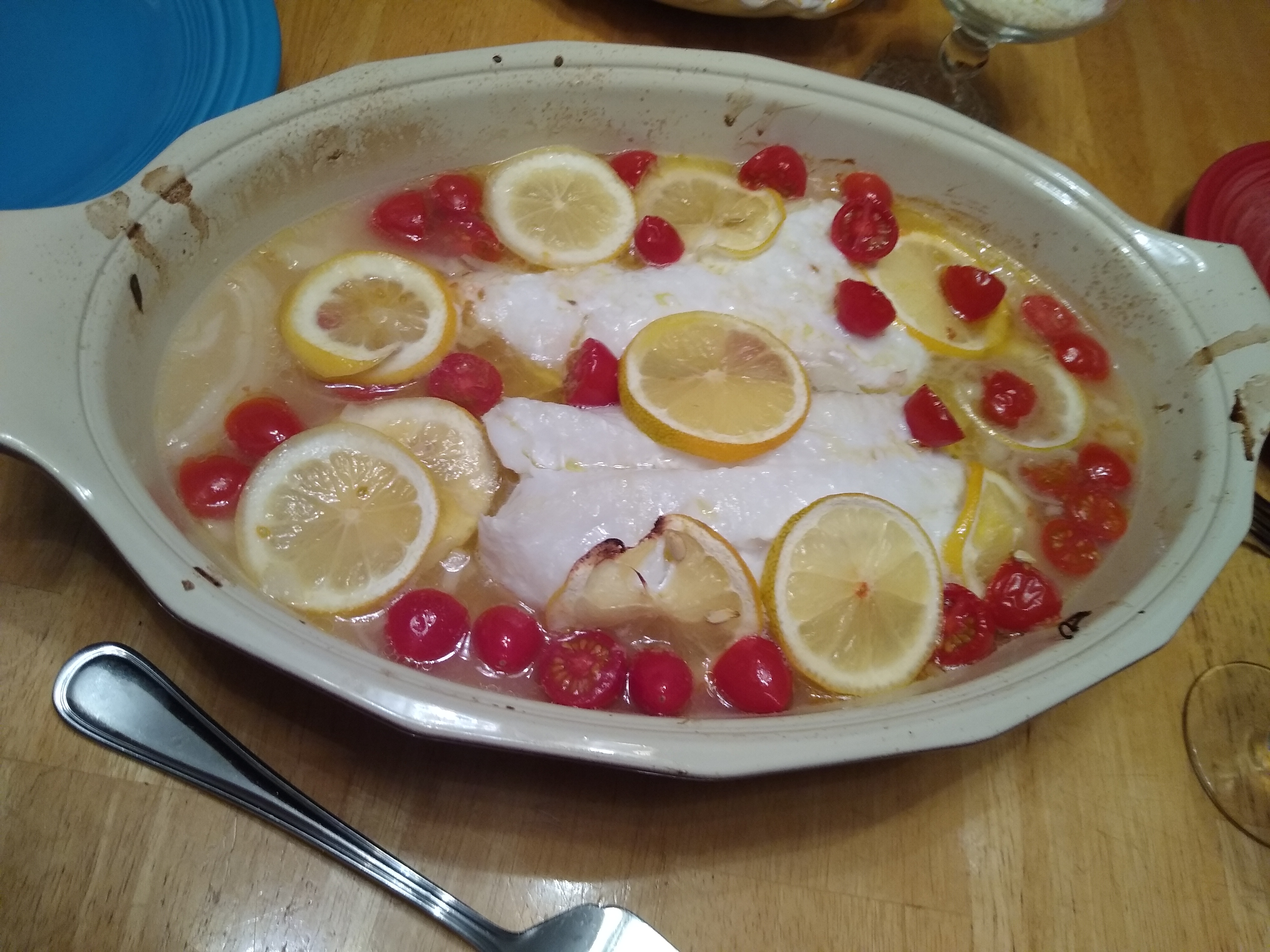 Cod baked with lemon and tomatoes