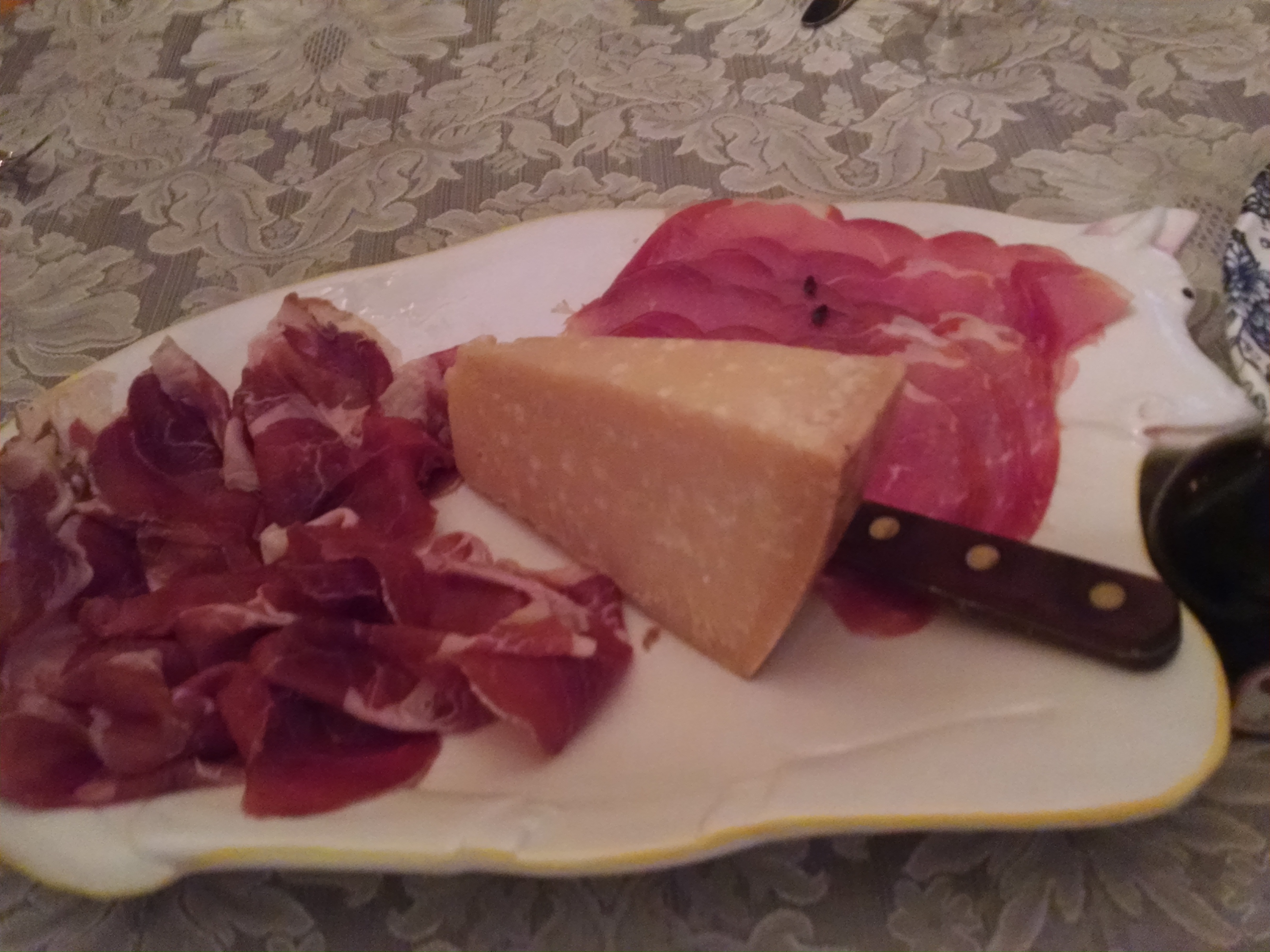 Aged Parmigiano Reggiano cheese between Culatello and domestic Prosciutto