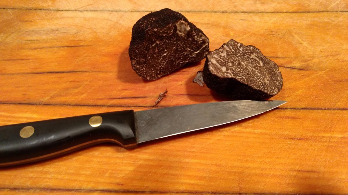 a cut black truffle