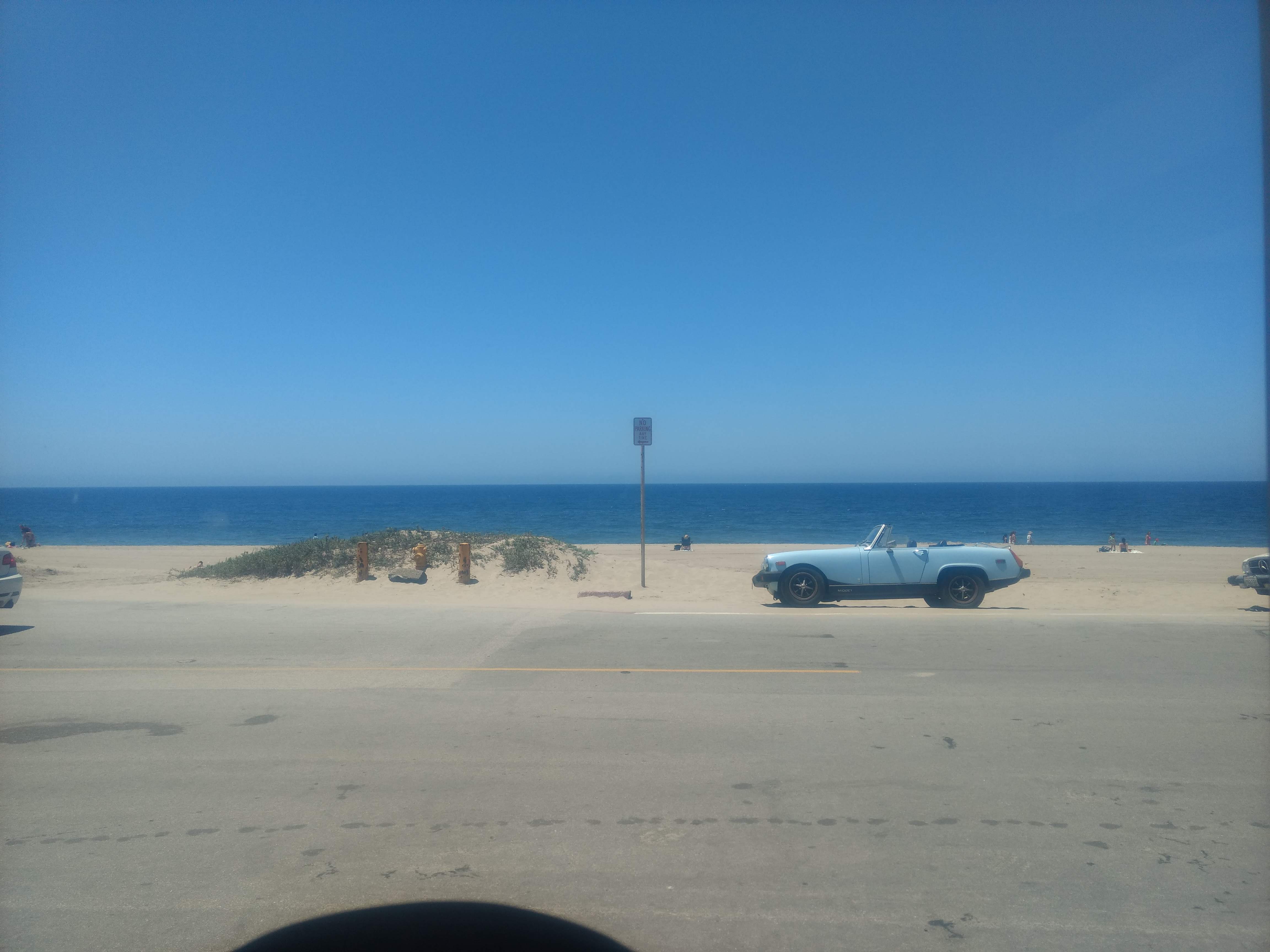 Malibu beach with blue convertible