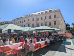 "Shady outdoor dining at a farmers market"